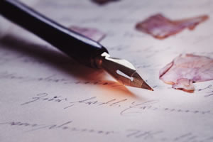 fountain pen on handwritten page and rose petal in soft purple light - meaning: beta reader choosing between literature and likeable