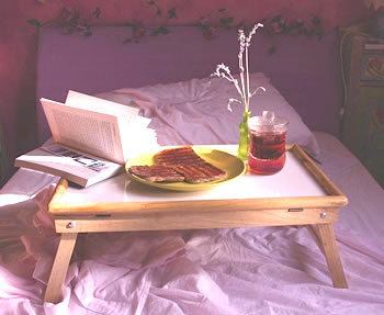 book on breakfast tray on bed with toast and tea - for new year resolutions