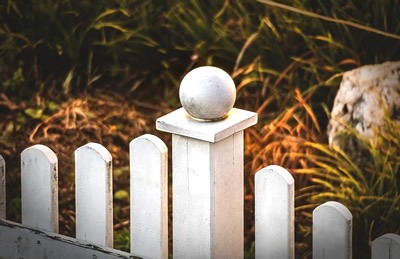 little white fence on garden border