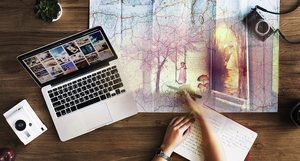 The writers dilemma - writing or research - woman hands on map bluring into book