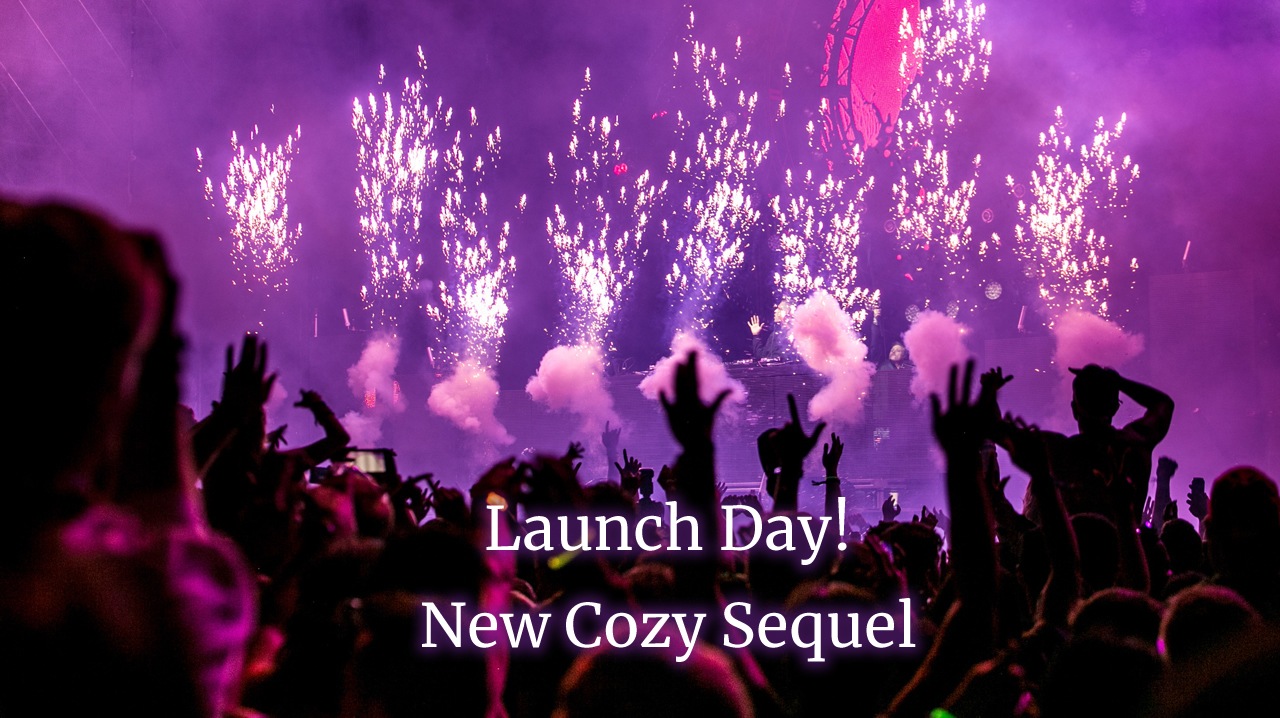 Crowd in silhouette, fireworks against purple lighting. Text: Launch Day! New Cozy Sequel