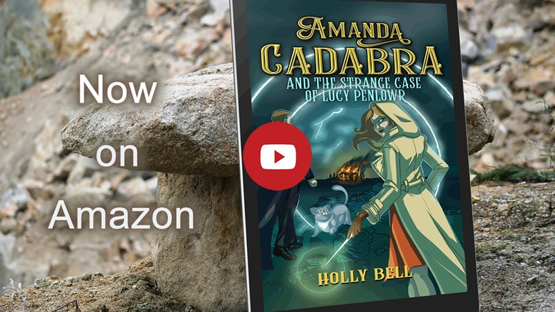 Link image to video of trailer for Amanda Cadabra and The Strange Case of Lucy Penlowr. Book leaning on Cornish granite. Text: Now on Amazon