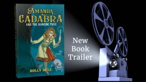 Amanda Cadabra and The Hanging Tree book in the light of a projector