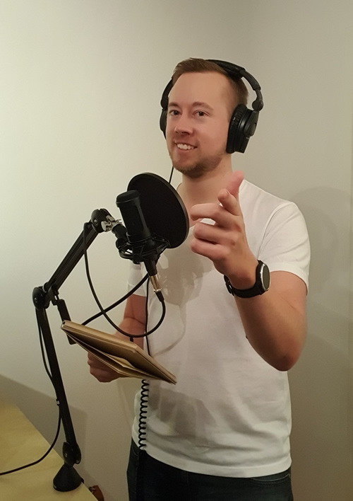 Simon Grunditz voice over artist standing in studeo recording