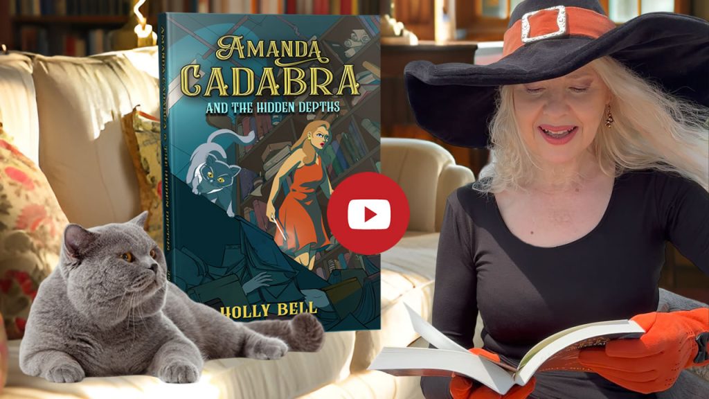 Click to go to video of Holly Bell reading Chapter 1 of Amanda Cadabra and The Hidden Depths. Image of Holly Bell in witch hat reading from Amanda Cadabra book while grey British Blue cat looks up at her grumpily from the sofa in a sunny room