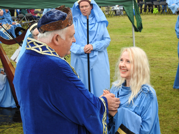 Holly Bell at the Gorsedh, Callington 2024, receiving her bardic name from the Grand Bard Pol Hodge