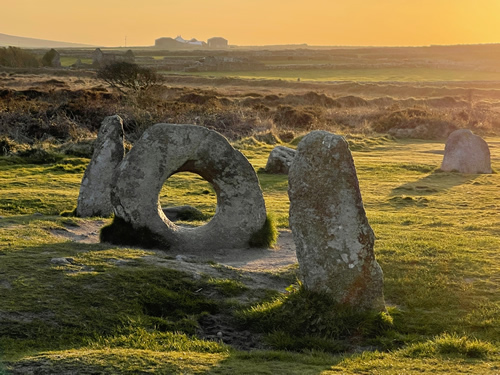 Men an Tol. Moorland with circular stone and and an upright stone, at sunset. By James Kitto