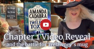 Link to Chapter 1 video. Image of Holly reading from The Twilight Toxin with Tempest (British Blue cat on sofa looking up at here. Behind him on the sofa is the book. Amanda Cadabra and The Twilight Toxin. text: Chapter 1 Video reveal and the battle for Trelawney's mug. Top left is a a pavement board: No Mugs. No Brew. (everythnng else)