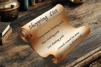 Open scroll on a vintage desk. Written on the scroll in script: Shopping List Young woman climbing a path Man climbing a path Cat climbing a path Cornish ruined tin mine on distant hill