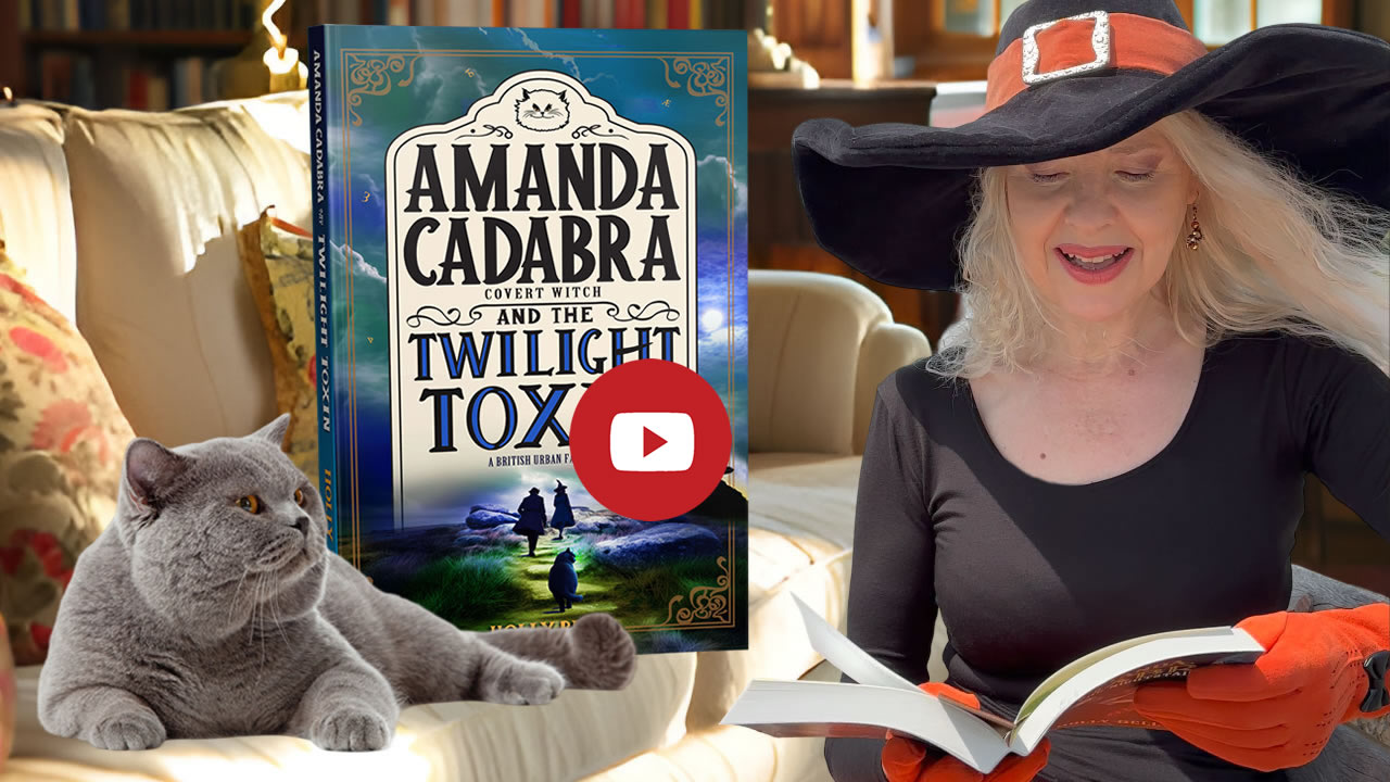 Link to Chapter 1 video. Image of Holly reading from The Twilight Toxin with Tempest (British Blue cat on sofa looking up at here. Behind him on the sofa is the book. Amanda Cadabra and The Twilight Toxin. 
