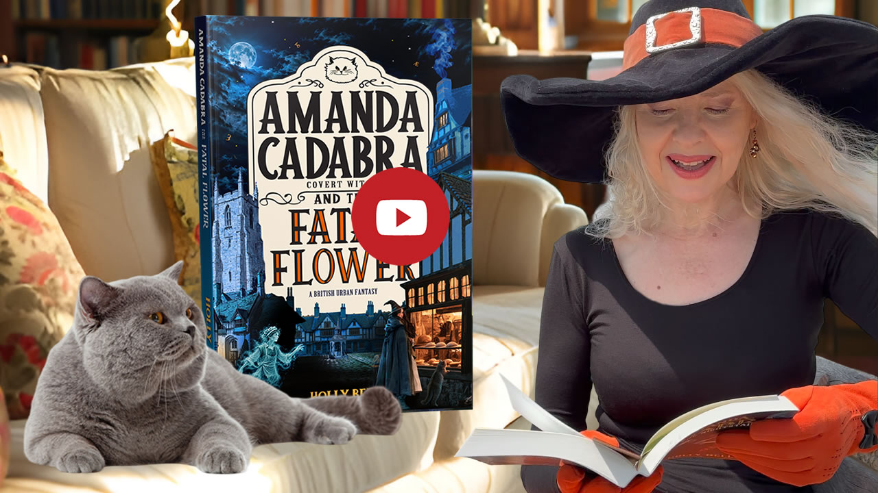 Link to Chapter 1 video. Image of Holly reading from The Twilight Toxin with Tempest (British Blue cat on sofa looking up at here. Behind him on the sofa is the book. Amanda Cadabra and The Fatal Flower