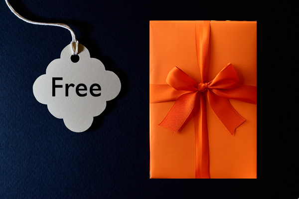 Price tag with Free on it and orange gift wrapped book on its right. back background